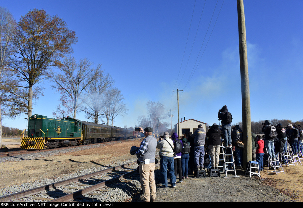 SMS Baldwin S-12 304 leading the passenger special on the very first photo runby of the day just south of the S. Woodstown Station. The photo line of photographers are getting to work with their cameras